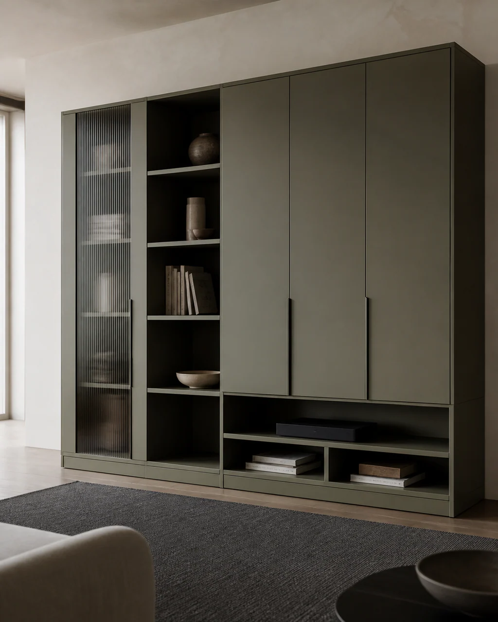 Muted olive aluminum living room storage with reeded glass display and closed full height cabinets